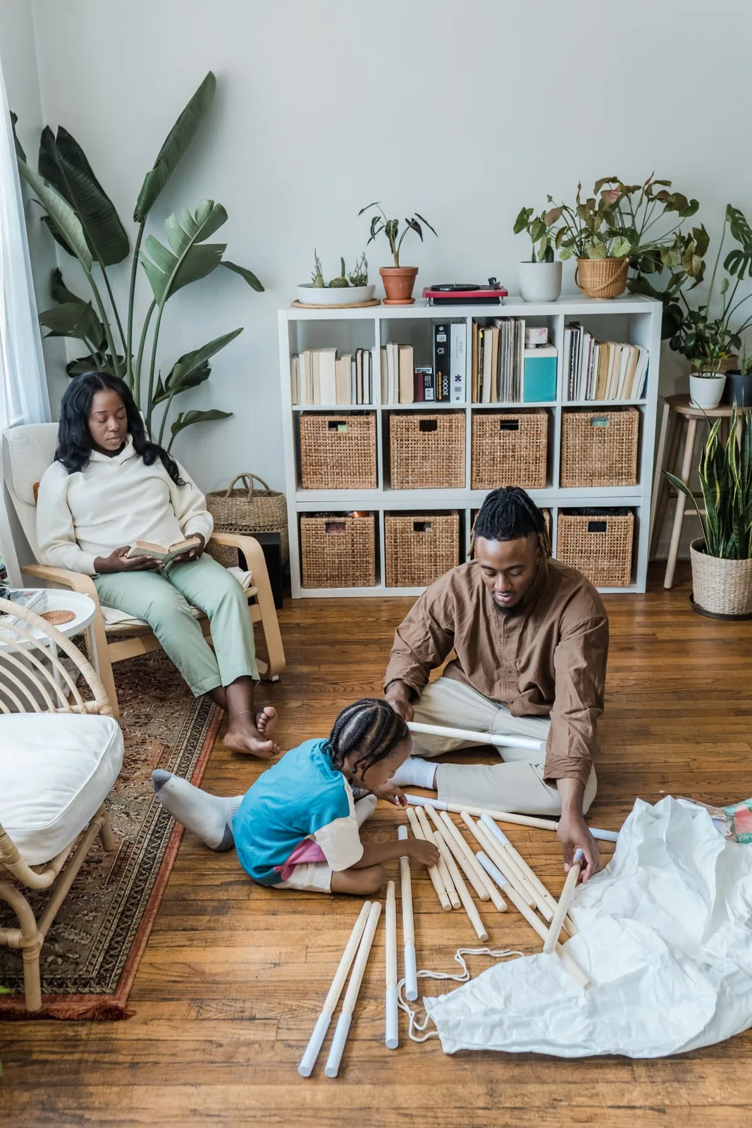 A family enjoys quality time together working on a DIY project in a cozy home setting.