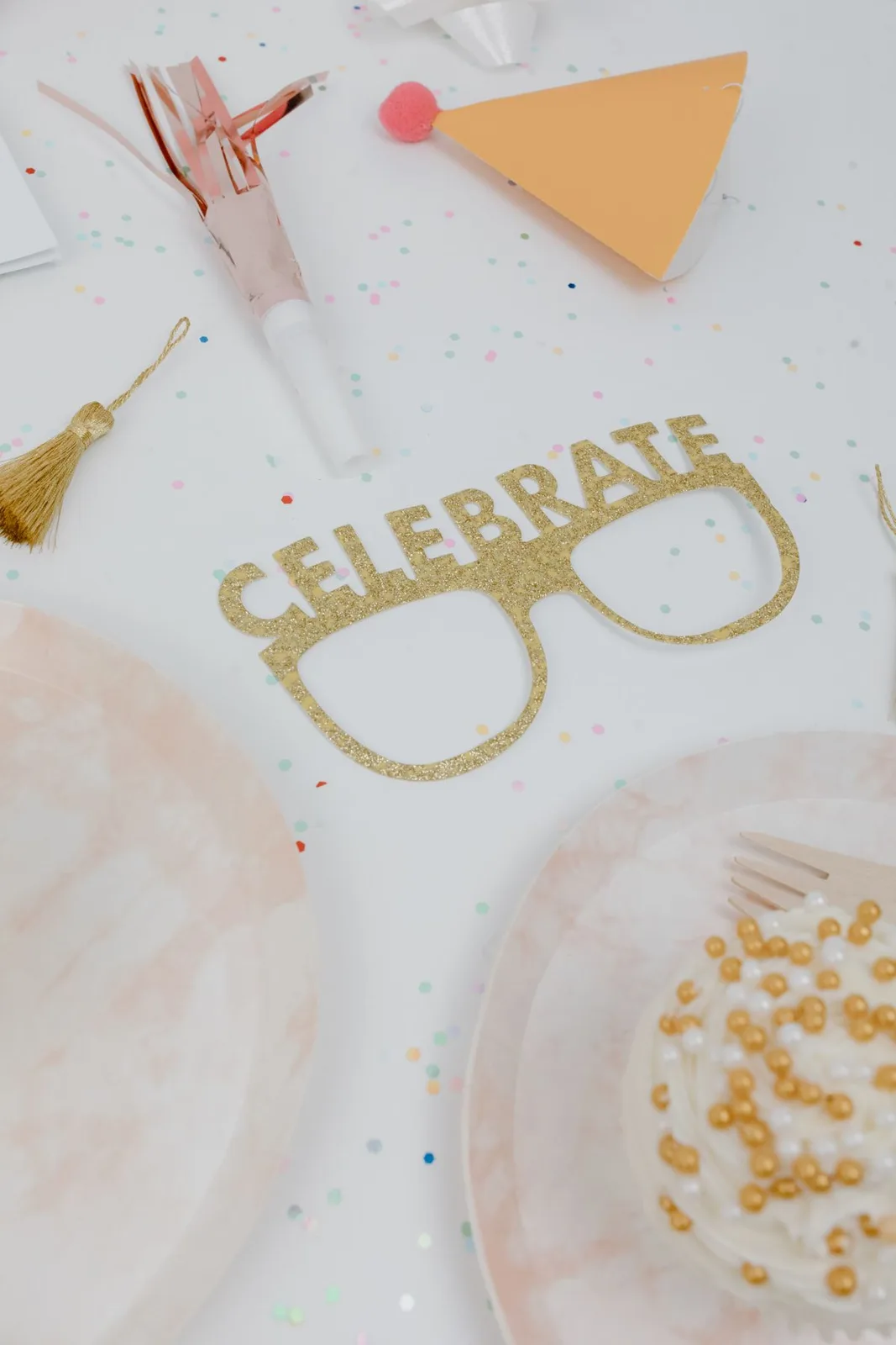 Elegant party table with confetti, cake, and celebrate decoration, perfect for celebrations.