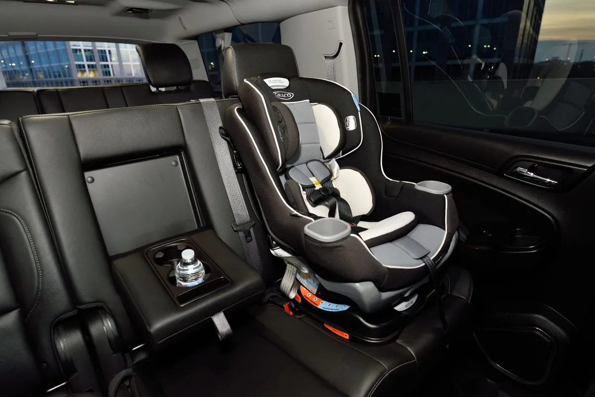 An empty child car seat in the rear of a vehicle.